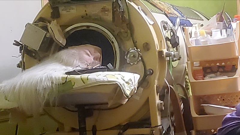 In this photo provided by Cindy McVey, her sister Martha Lillard rests in her iron lung on...