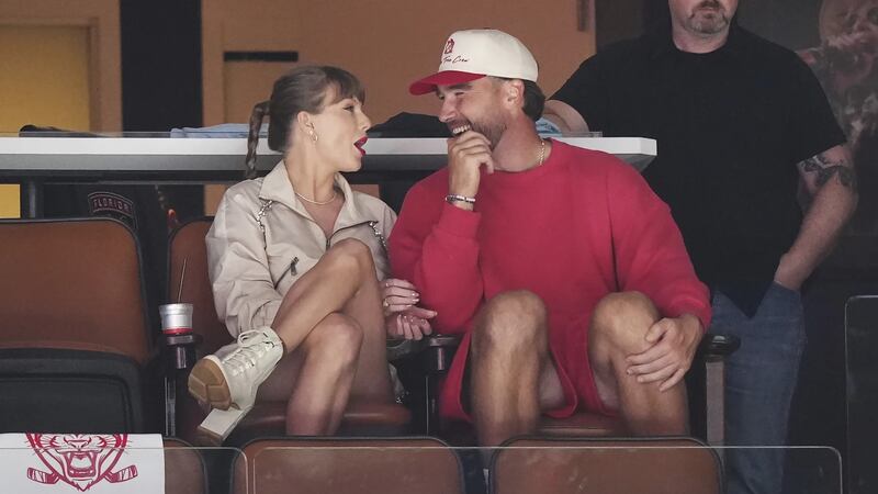 Singer Taylor Swift, left, and Kansas City Chiefs football player Travis Kelce, front right,...
