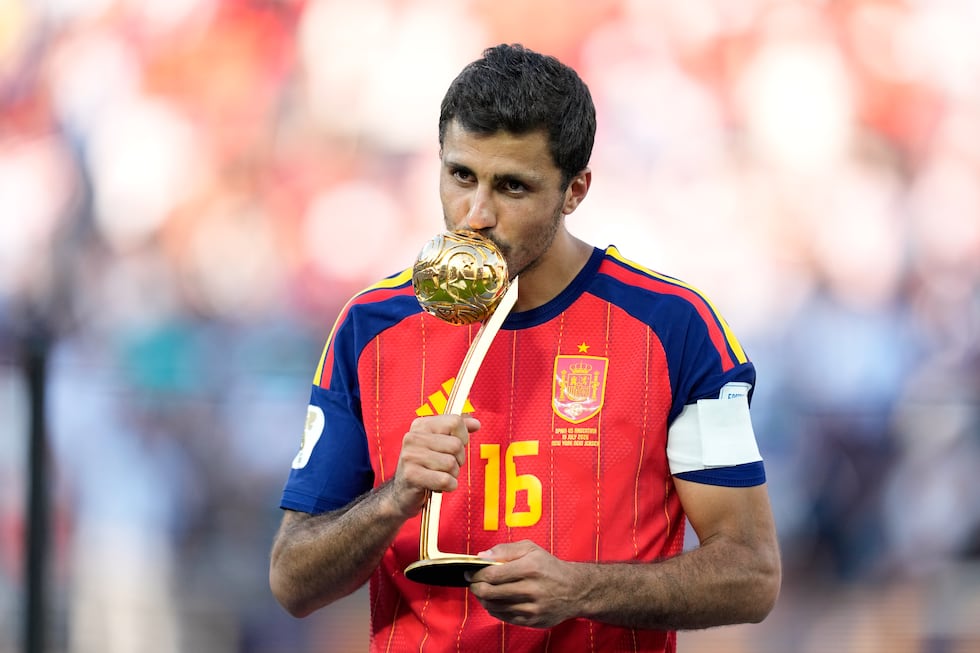 Spain's Rodri poses with the tournament's best player award at the end of the World Cup final...